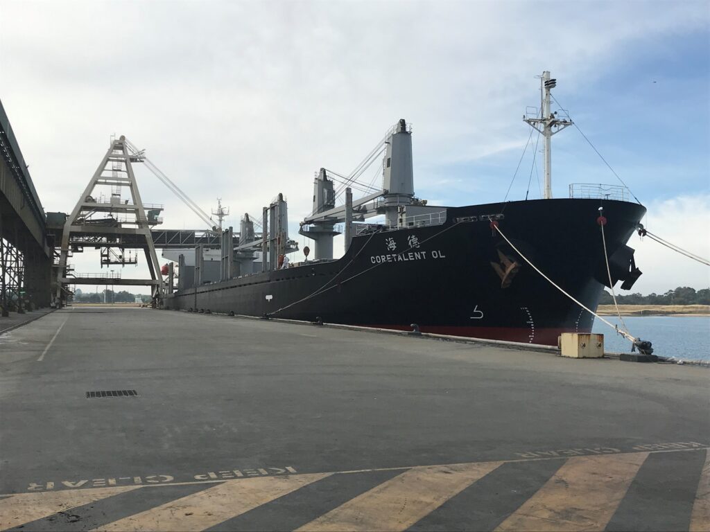 black ship docked in harbour.